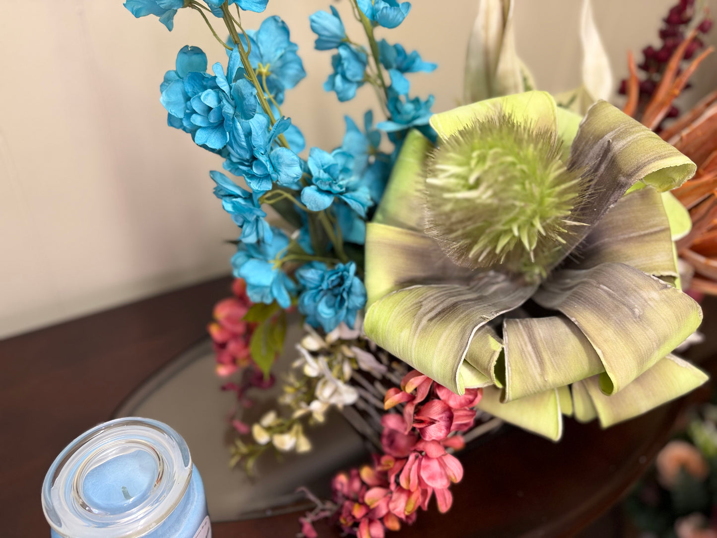 Floral Arrangement – Teal & Terracotta Centerpiece with Sculptural Green Foliage in Textured Planter