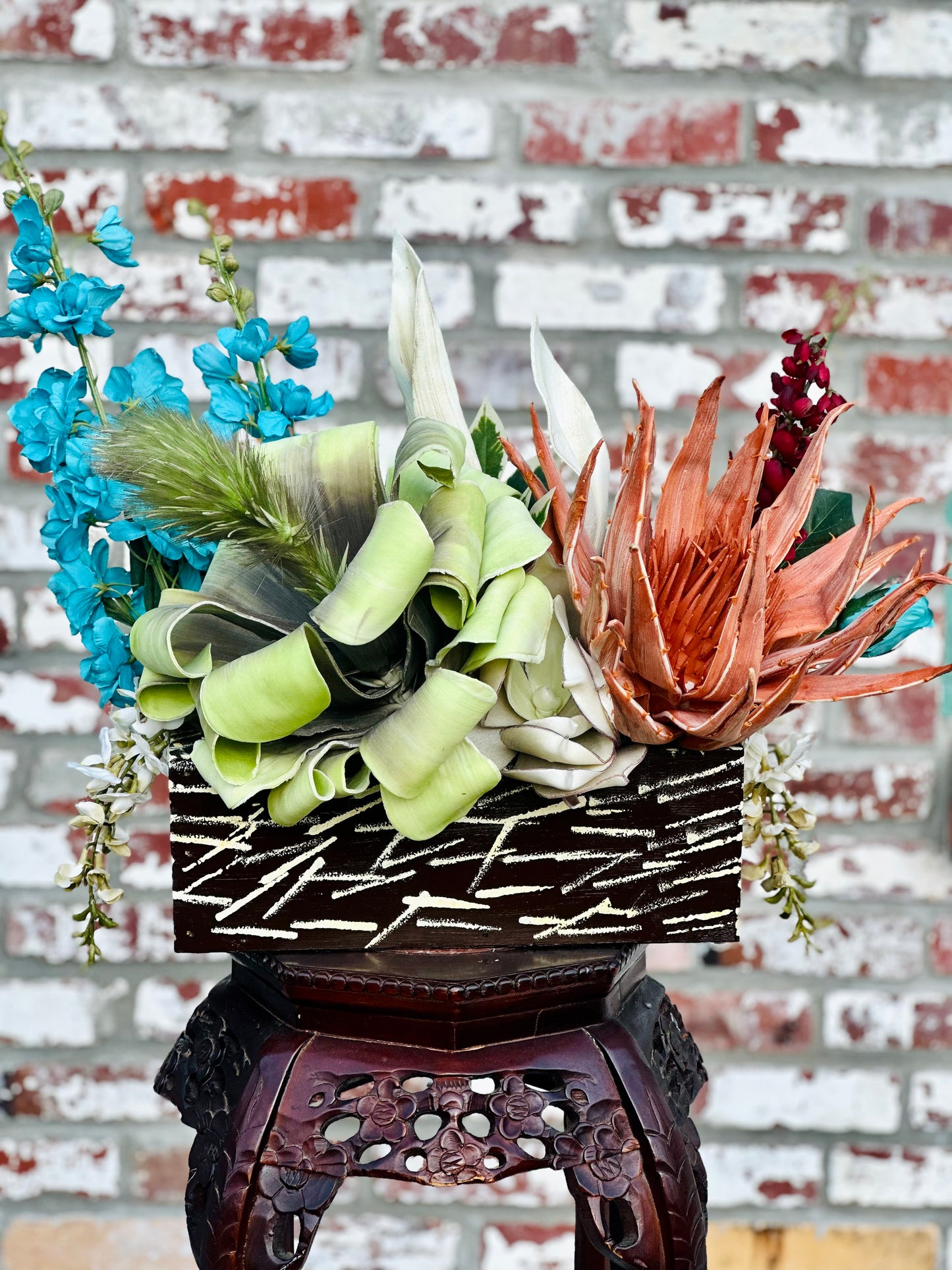 Floral Arrangement – Teal & Terracotta Centerpiece with Sculptural Green Foliage in Textured Planter