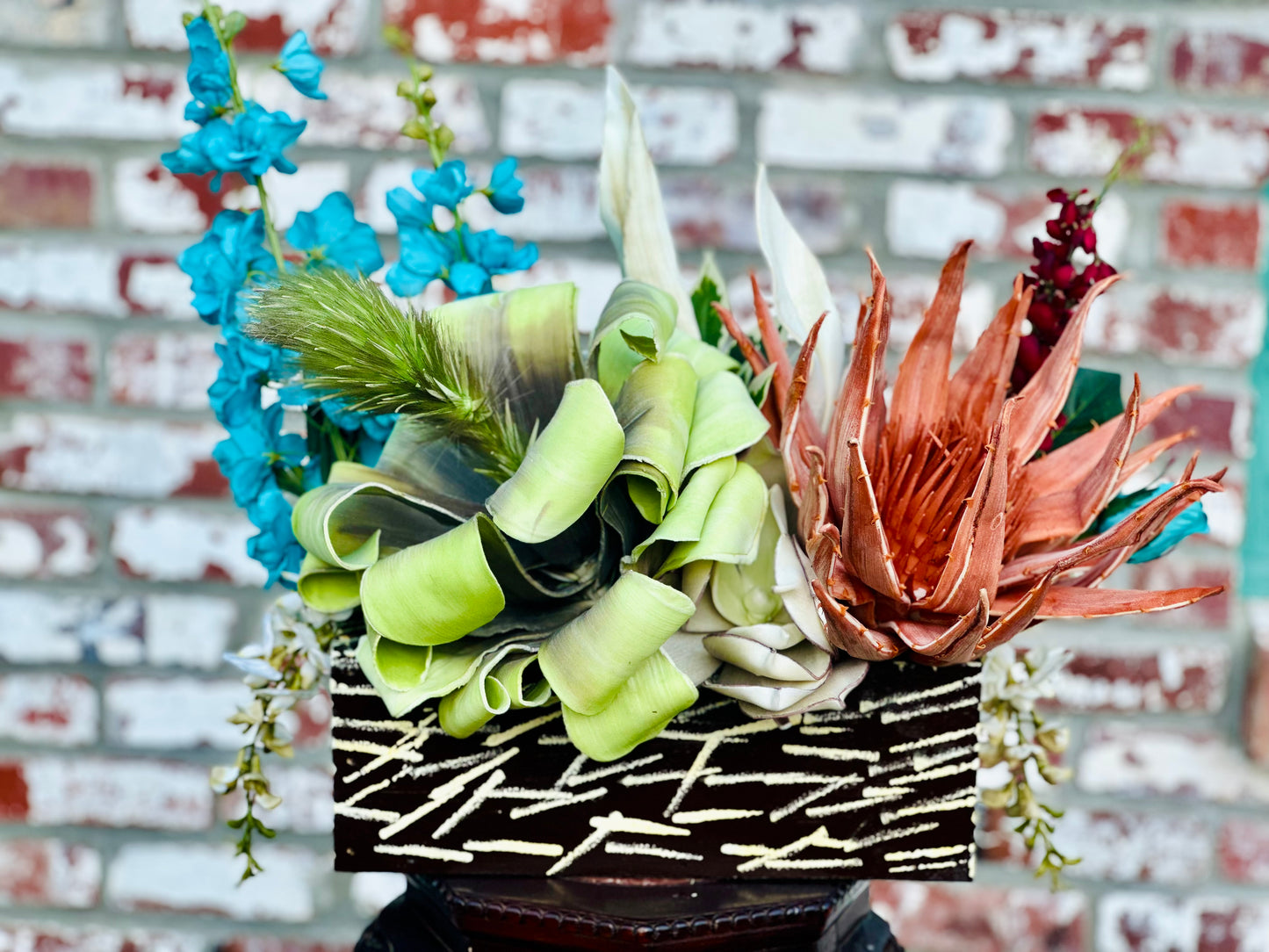 Floral Arrangement – Teal & Terracotta Centerpiece with Sculptural Green Foliage in Textured Planter